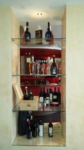 a shelf filled with lots of bottles of alcohol at Hotel La Terrazza in Wetzlar