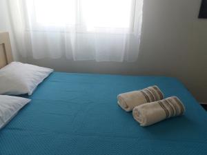 Postel nebo postele na pokoji v ubytování Qeparo Antonio Rooms