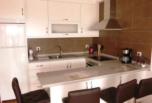 a kitchen with white cabinets and a counter top at 100 meters from the ocean in Callao Salvaje