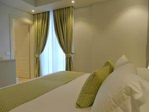 Posteľ alebo postele v izbe v ubytovaní Hotel Villa Garuti