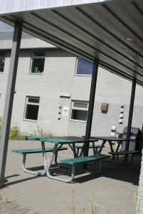 a picnic table in front of a building at Residence & Conference Centre - Sudbury West in Sudbury