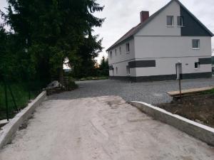 a large white house and a road next to a building at apartment Dana in HoÅ¡Å¥ka