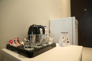 a tray with glasses and a tea kettle on a counter at Lamar Al Bawadi Hotel in Jeddah