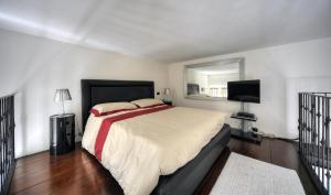 a bedroom with a large bed and a television at ROME LUXURY HOUSE - THE SUITE in Rome