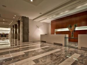 a lobby with a reception desk in a building at EB Hotel Miami Airport in Miami