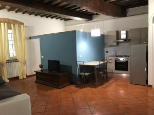 a kitchen with a blue wall and a table and chairs at La casa di Benedetta in Perugia