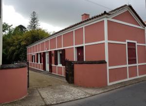 un edificio rojo y blanco con una puerta en Casa Dona Beatriz, en Furnas
