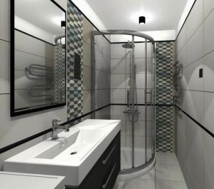 ein Bad mit einem Waschbecken und einer Glasdusche in der Unterkunft Great location, stylish apartment in Jūrmala