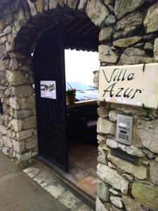 a door into a stone building with a sign on it at Villa Azur Cap d'Ail in Cap d'Ail