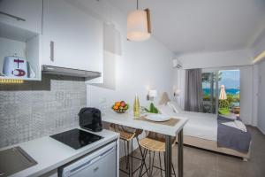 a kitchen and living room with a bed and a table at Mirabella Apartments in Agios Nikolaos +78 photos