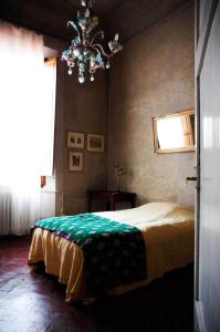 a bedroom with a bed and a chandelier at Le Tre Stanze in Florence