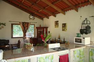 a kitchen with a stove and a counter top at Thermal Paradise Villa in Caluco