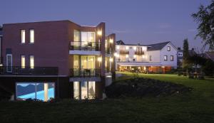 a large house with lights on the side of it at Hotel Creusen in Epen