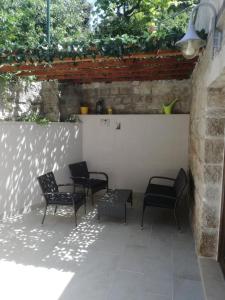 a group of chairs sitting on a patio at Apartman Ivana in Splitska