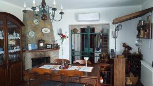 a dining room with a table and a fireplace at Casa da Boa Vista em Viadal in Vale de Cambra