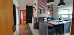 a kitchen with a counter and a brick wall at Apartment Marta in Pag