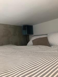 a bedroom with a large bed with white sheets at Birch central studio on main square in Ljubljana +15 photos