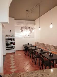 a room with tables and chairs and a wine rack at camere pula in Pula