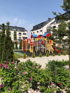 a playground in a park with a play equipment at Malūnų vilos in Palanga