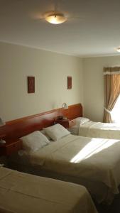 מיטה או מיטות בחדר ב-Apart Hotel Austral