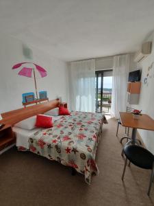 a bedroom with a large bed with a pink umbrella at Kvarner View Rooms in Kraljevica