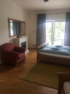 a bedroom with a bed and a chair and a window at Apartment am Friedrich Ebert Park mit über 100qm Wohnfläche in Hamm +19 photos