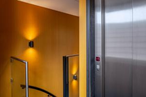 a bathroom with yellow walls and a mirror at Cityview Hotel in Amsterdam +76 photos