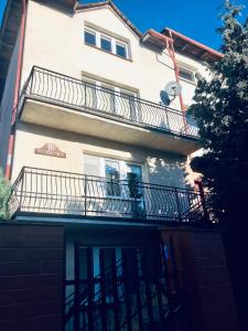 an apartment building with balconies and a balcony at Relax in Ostrowo