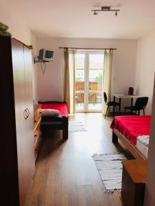a bedroom with two beds and a dining room with a table at Dom Wypoczynkowy Sztorm in Ostrowo