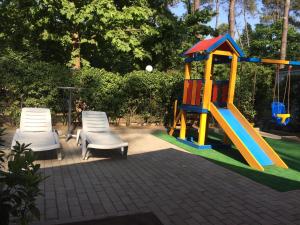 a playground with two chairs and a slide at Ef Palace Shekvetili in Shekhvetili