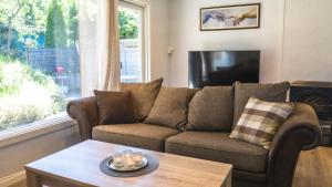 a living room with a couch and a coffee table at Krossmyrhill. Great house in Eik