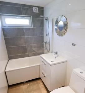 a bathroom with a toilet and a sink and a shower at Krossmyrhill. Great house in Eik