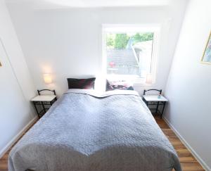 a bed in a room with a window at Krossmyrhill. Great house in Eik