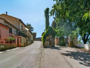 an empty street in a village with trees and buildings at Villa Eugenia in Livorno