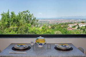 a table with plates on it with a view of a city at Villa Eugenia in Livorno