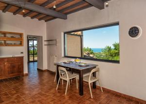 a dining room with a table and chairs and a window at Villa Eugenia in Livorno
