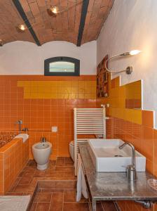 a bathroom with a sink and a tub and a toilet at Villa Eugenia in Livorno