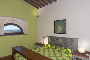 a bedroom with a bed in a room with a window at Villa Eugenia in Livorno