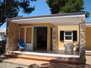 a small house with a patio at Apartamentos Playa Calan Blanes in Cala en Blanes