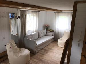 a living room with a couch and two chairs at Vacation House Terraces in Sigulda