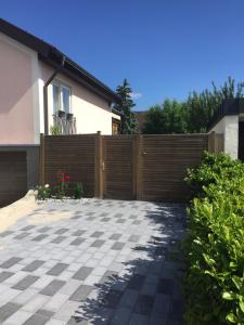 a fence in front of a house with a driveway at Ferienwohnung Rose in Villingen-Schwenningen