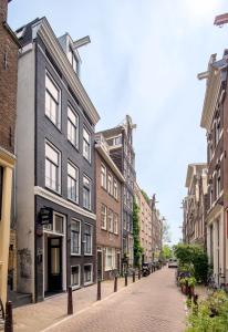 a cobblestone street in a city with buildings at Cityview Hotel in Amsterdam