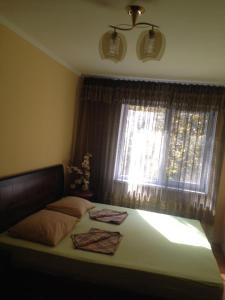 a bedroom with a bed with two towels on it at Apartment on Abazgaa 53-4 in Gagra