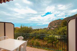 a balcony with a table and a view of the ocean at Residence Calavà in Gioiosa Marea