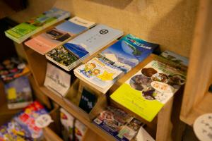 a bunch of books sitting on a shelf at Hotel New Nishino in Kagoshima