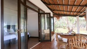 a room with a table and chairs and a bedroom at Moon Beach Villas El Nido in El Nido