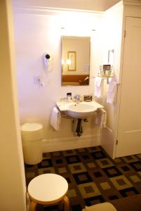 a bathroom with a sink and a toilet and a mirror at The Mosser Hotel in San Francisco +37 photos