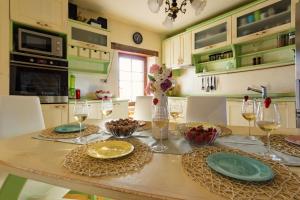a kitchen with a table with plates and wine glasses at Casa Romantica in Umag
