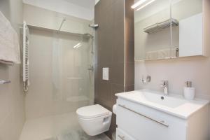a bathroom with a toilet and a sink and a shower at Apartment Movie in Primošten +44 photos