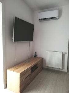 a living room with a flat screen tv on a wall at Apartament_20 in Dziwnówek